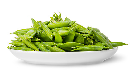 Image showing Pile of green peas in pods on white plate