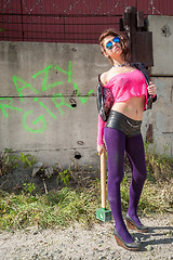 Image showing Pretty girl in pink net blouse with sledge hammer