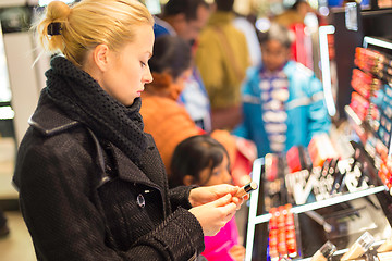 Image showing Beautiful woman shopping in beauty store.