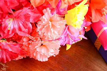 Image showing present gift box and flower bouquet on silk