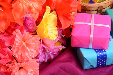 Image showing present gift box and flower bouquet on silk