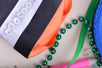 Image showing Office table with ribbons, pencils and pearls