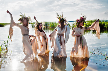 Image showing Pretty women with flower wreath in water