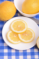 Image showing Fresh juicy sliced lemon on a ceramic plate.