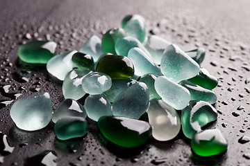 Image showing hip of wet glass pieces polished by the sea 