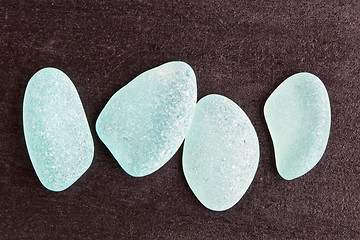 Image showing four blue glass pieces polished by the sea