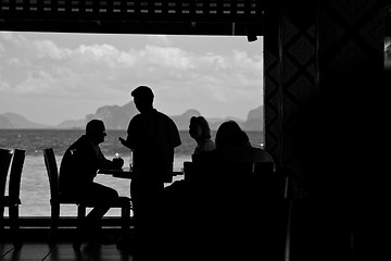 Image showing Silhouette of people eating 