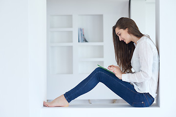 Image showing woman at home using tablet