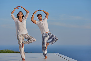 Image showing young couple practicing yoga