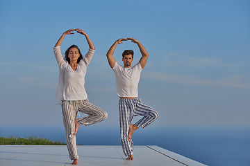 Image showing young couple practicing yoga