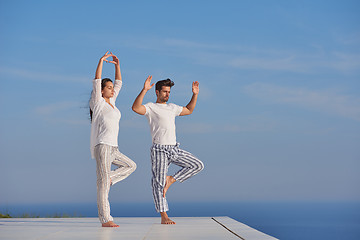 Image showing young couple practicing yoga