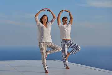 Image showing young couple practicing yoga