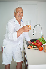 Image showing man cooking at home preparing salad in kitchen