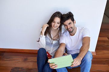 Image showing couple at modern home using tablet computer
