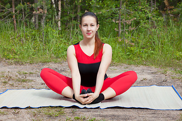 Image showing The young girl engaged in yoga class.