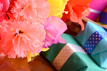 Image showing present gift box and flower bouquet on silk