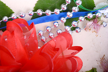 Image showing Office table with ribbons, flowers, pencils and pearls