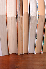 Image showing Old books leaning against each other for sale