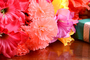 Image showing present gift box and flower bouquet on silk