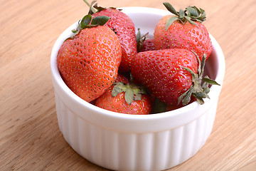 Image showing Close up strawberry on wooden plate