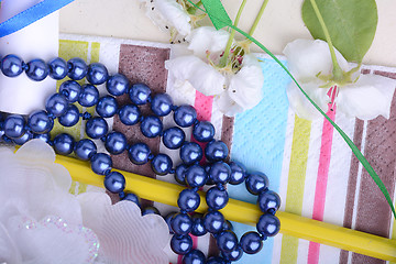 Image showing Office table with flower, ribbons, pencils, pearls