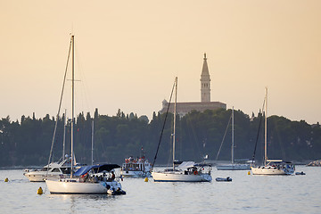 Image showing Sailboats anchored in Rovinj harbour at sunset
