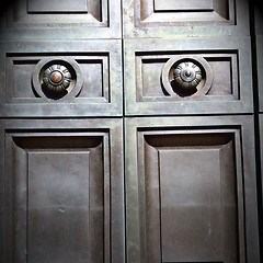 Image showing in london antique brown door  rusty  brass nail and light