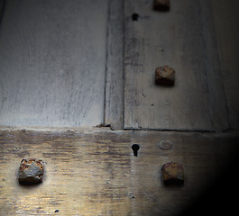 Image showing in london antique brown door  rusty  brass nail and light