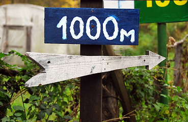 Image showing Rustic wooden road direction sign