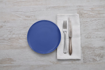 Image showing Plate, cutlery and cloth on wood