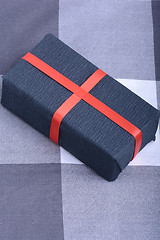 Image showing Black gift box with red ribbon
