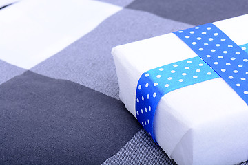 Image showing White gift box with blue ribbon