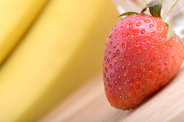 Image showing healthy strawberry smoothie with fruits on wooden background