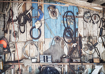 Image showing old tools hanging on wooden wall