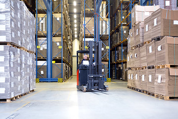 Image showing Worker In Forklift Examining Stock