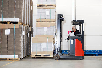 Image showing Worker In Forklift Examining Stockpile