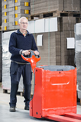 Image showing Worker Standing With Handtruck At Warehouse