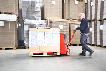 Image showing Worker Transporting Goods On Handtruck