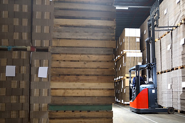 Image showing Man In Forklift Examining Stock