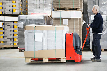 Image showing Worker With Loaded Handtruck In Warehouse