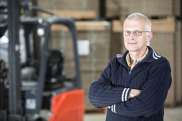Image showing Confident Worker Standing At Warehouse