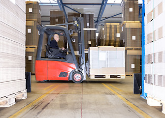 Image showing Worker Carrying Goods On Forklift