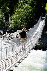Image showing Man on suspension bridge