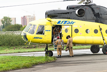 Image showing Rescuers load into helicopter MI-8 