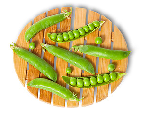 Image showing Pods of peas on bamboo board top and front view