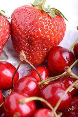 Image showing Sweet cherries and strawberries close up