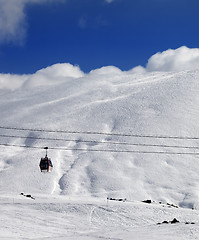 Image showing Gondola lift and off-piste slope at sun day