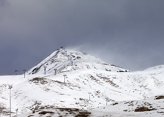 Image showing Ski slopes in little snow year at bad weather day