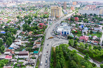 Image showing Aerial city view on crossroad, carshop and houses