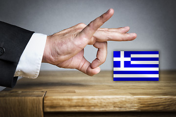 Image showing Man shoots Greek Flag off